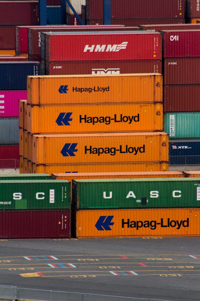 a-bunch-of-cargo-containers-stacked-on-top-of-each-other-69yfizauznk