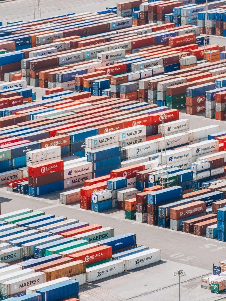 a-large-group-of-shipping-containers-are-stacked-together-j8i0xxivl7g